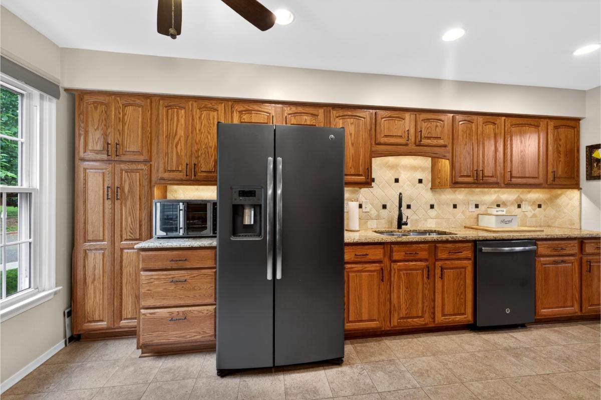 7347 Swan Point Way, Unit 122 Columbia, MD 21045 - Photo 14 of 54 a kitchen with granite countertop a refrigerator and a sink