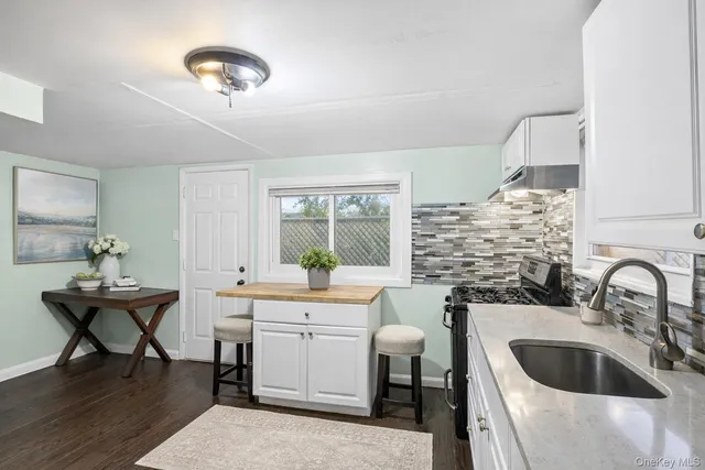 a view of empty room with a window and wooden floor