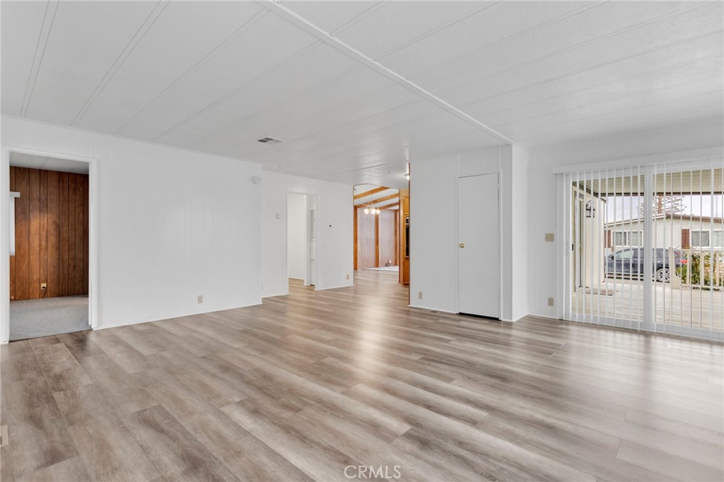 15252 Seneca Road, Unit 241 Victorville, CA 92392 - Photo 13 of 30 a view of an empty room with wooden floor and a window