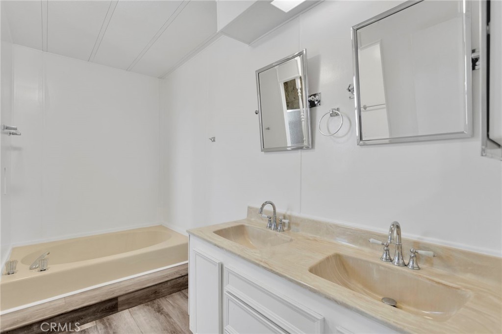 15252 Seneca Road, Unit 241 Victorville, CA 92392 - Photo 18 of 30 a bathroom with a granite countertop sink and a bathtub