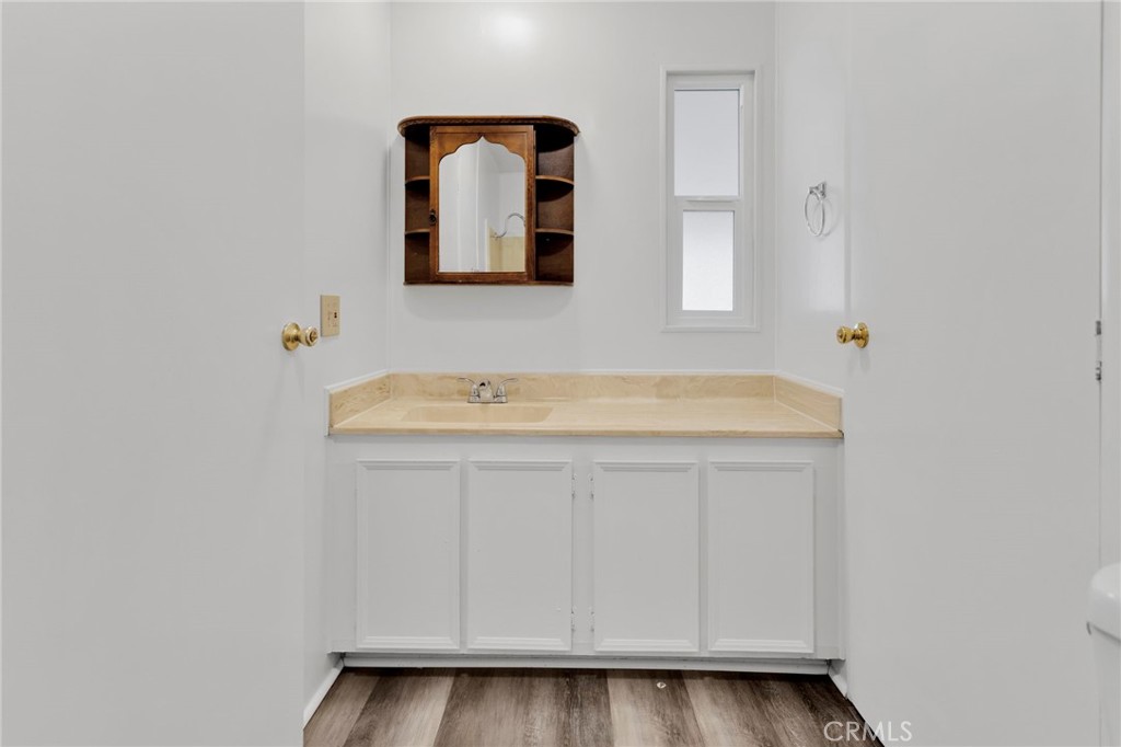 15252 Seneca Road, Unit 241 Victorville, CA 92392 - Photo 22 of 30 a bathroom with a sink and a mirror