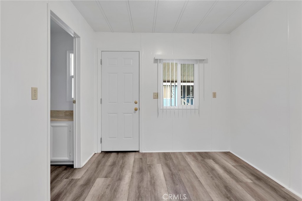 15252 Seneca Road, Unit 241 Victorville, CA 92392 - Photo 23 of 30 a view of an empty room with wooden floor