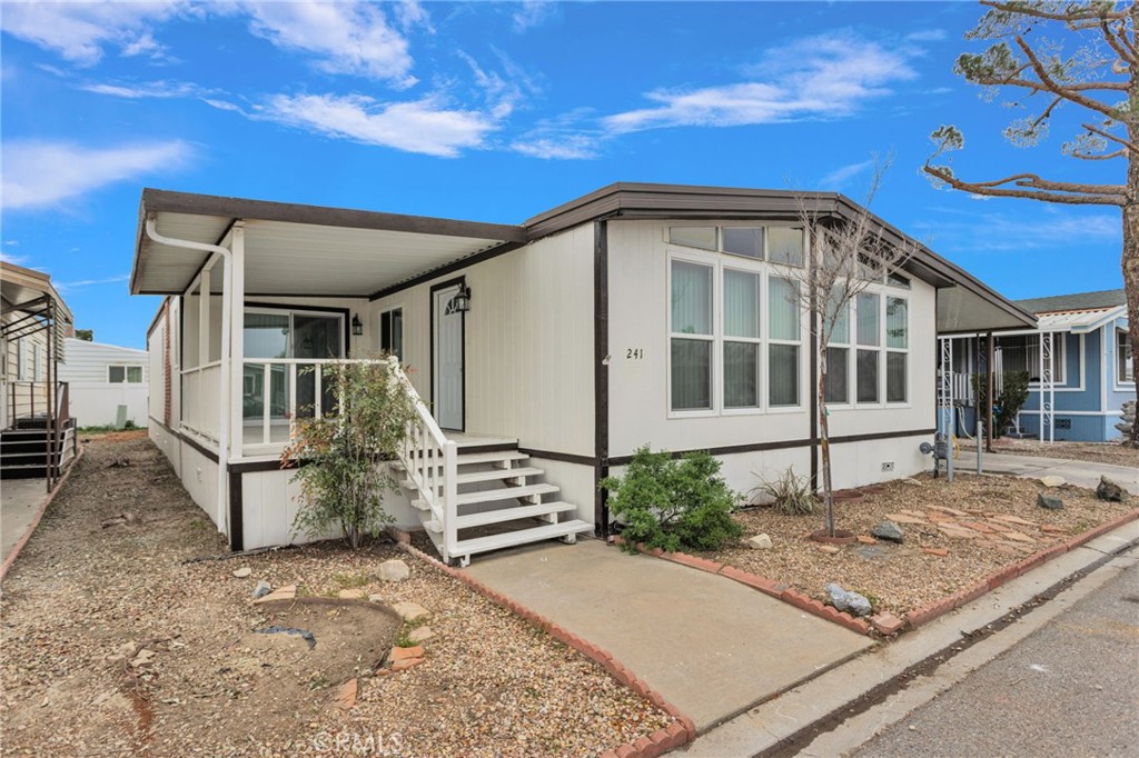 15252 Seneca Road, Unit 241 Victorville, CA 92392 - Photo 3 of 30 a front view of a house with a yard