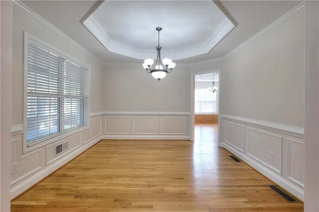 a view of a room with wooden floor and window