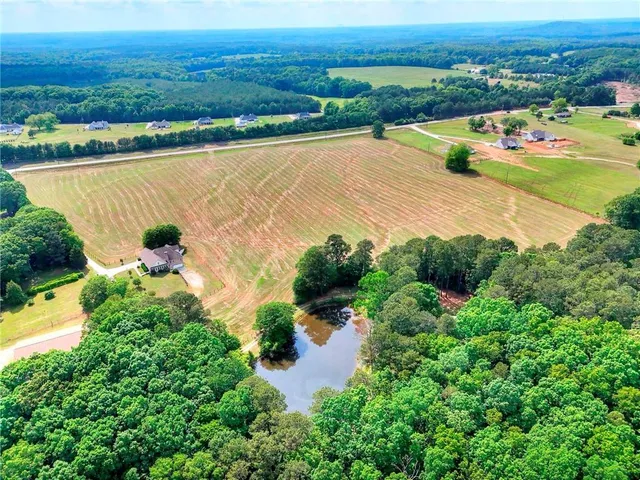 an aerial view of lake and residential houses with outdoor space and river