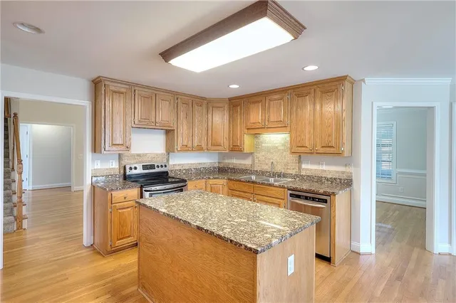 a kitchen with a stove a refrigerator and a sink