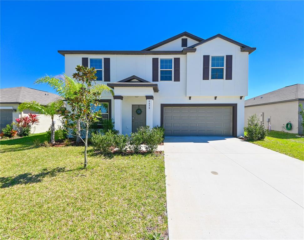 6898 Emerald Spring Loop New Port Richey, FL 34653 - Photo 1 of 1 a front view of a house with a yard and garage