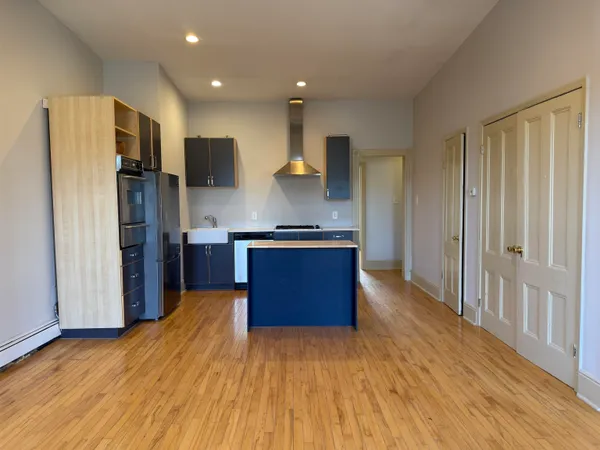 a kitchen with stainless steel appliances granite countertop a refrigerator and a stove