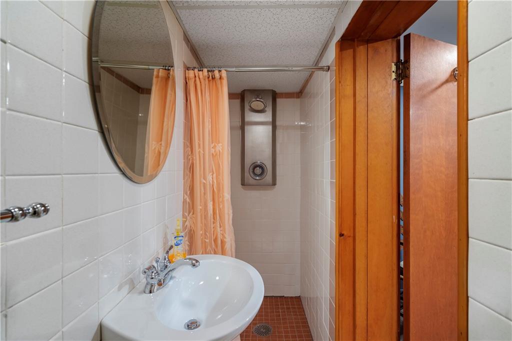 801 Spring Street Latrobe, PA 15650 - Photo 23 of 25 a bathroom with a sink a mirror a vanity and window