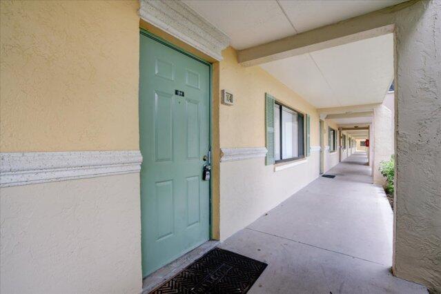 1104 Meadows Circle, Unit 1104 Boynton Beach, FL 33436 - Photo 11 of 27 a view of a hallway with entryway and front door