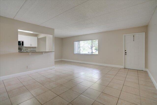 1104 Meadows Circle, Unit 1104 Boynton Beach, FL 33436 - Photo 12 of 27 a view of a kitchen with windows and white walls