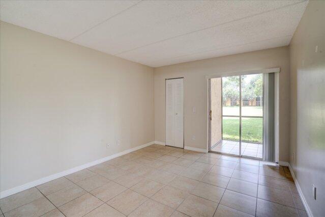 1104 Meadows Circle, Unit 1104 Boynton Beach, FL 33436 - Photo 19 of 27 a view of an empty room with a window