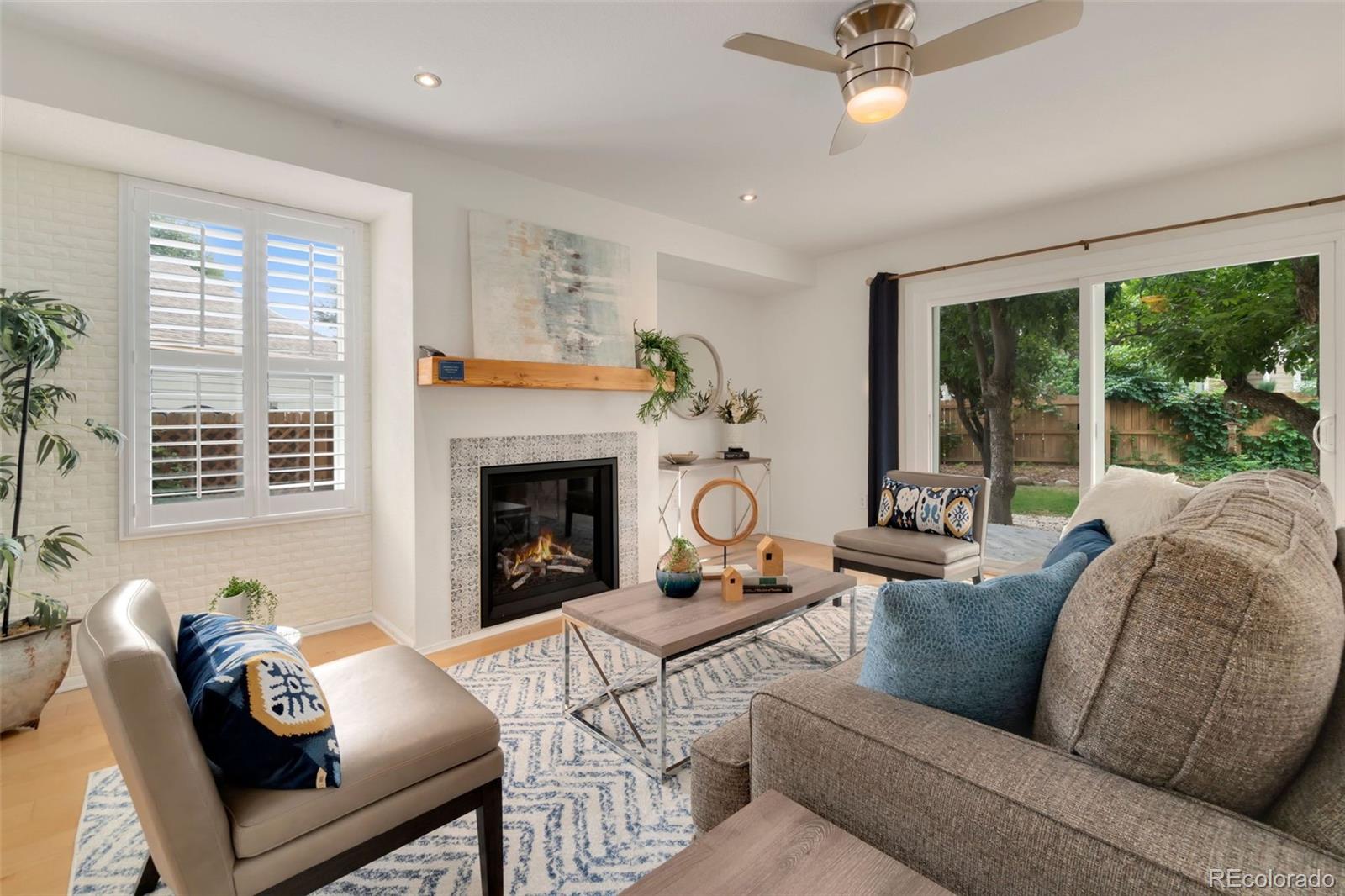 9752 Quay Loop Westminster, CO 80021 - Photo 13 of 27 a living room with furniture and a fireplace