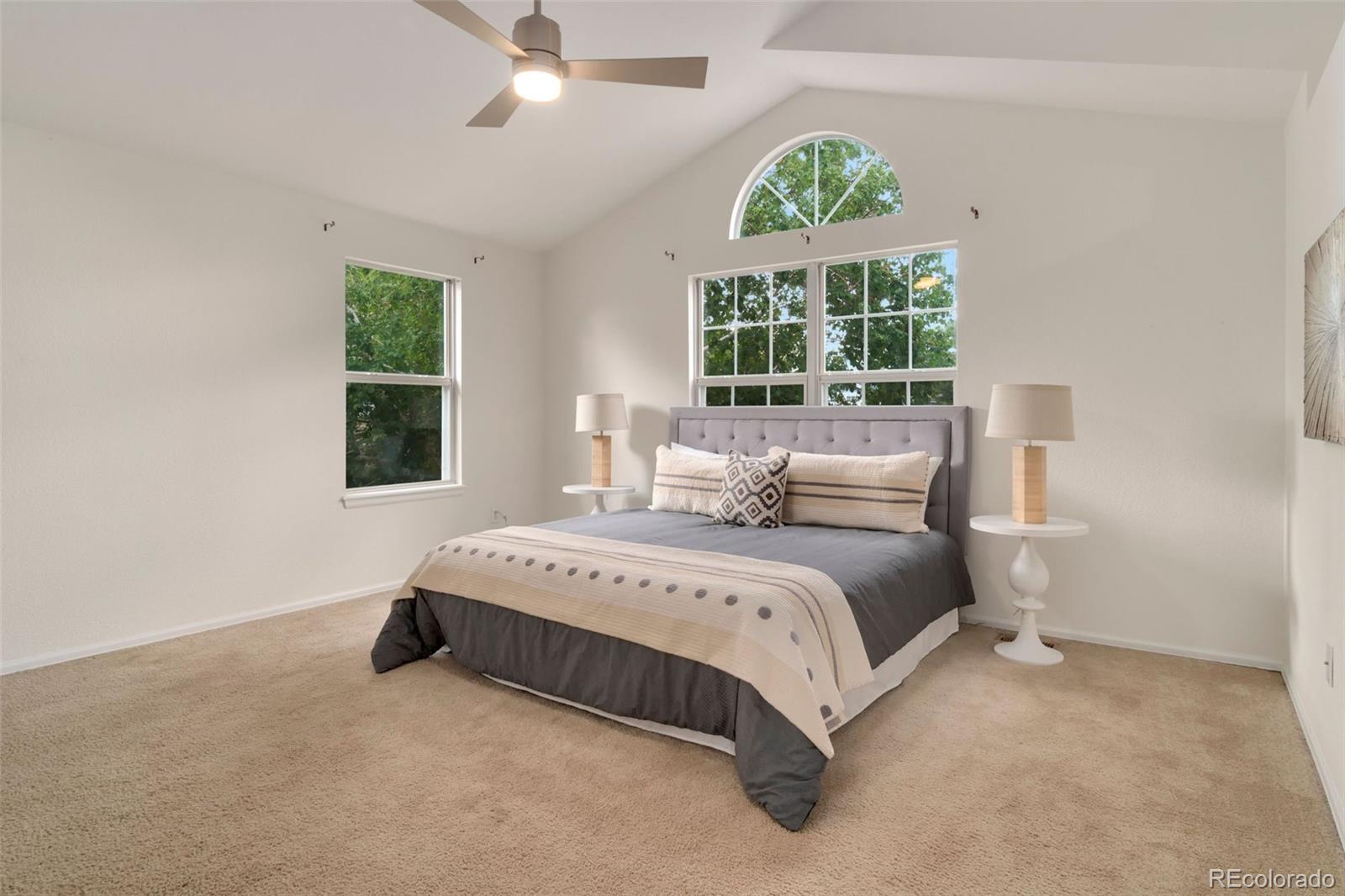 9752 Quay Loop Westminster, CO 80021 - Photo 15 of 27 a spacious bedroom with a bed and a large window