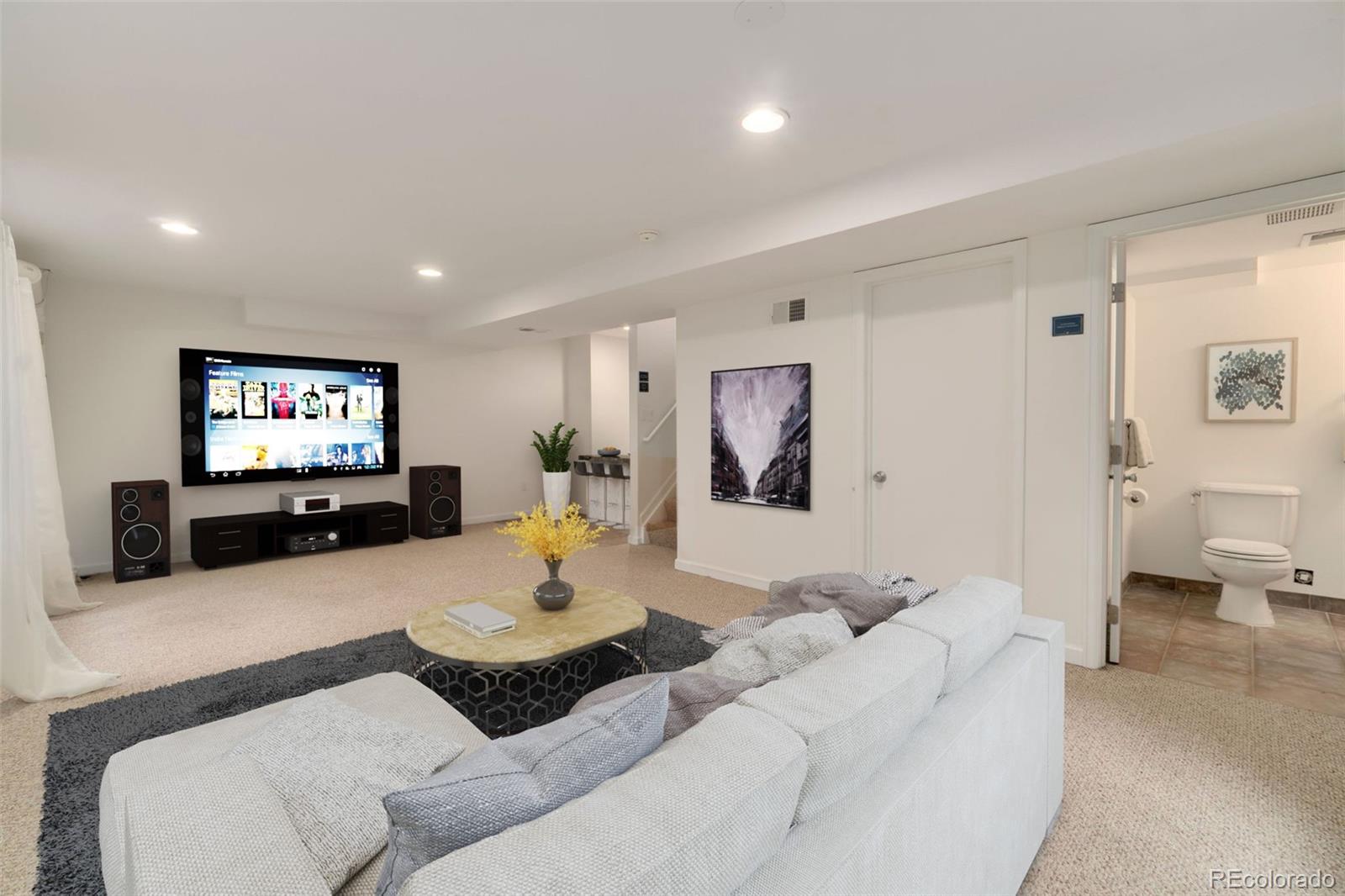 9752 Quay Loop Westminster, CO 80021 - Photo 22 of 27 a living room with furniture and a flat screen tv