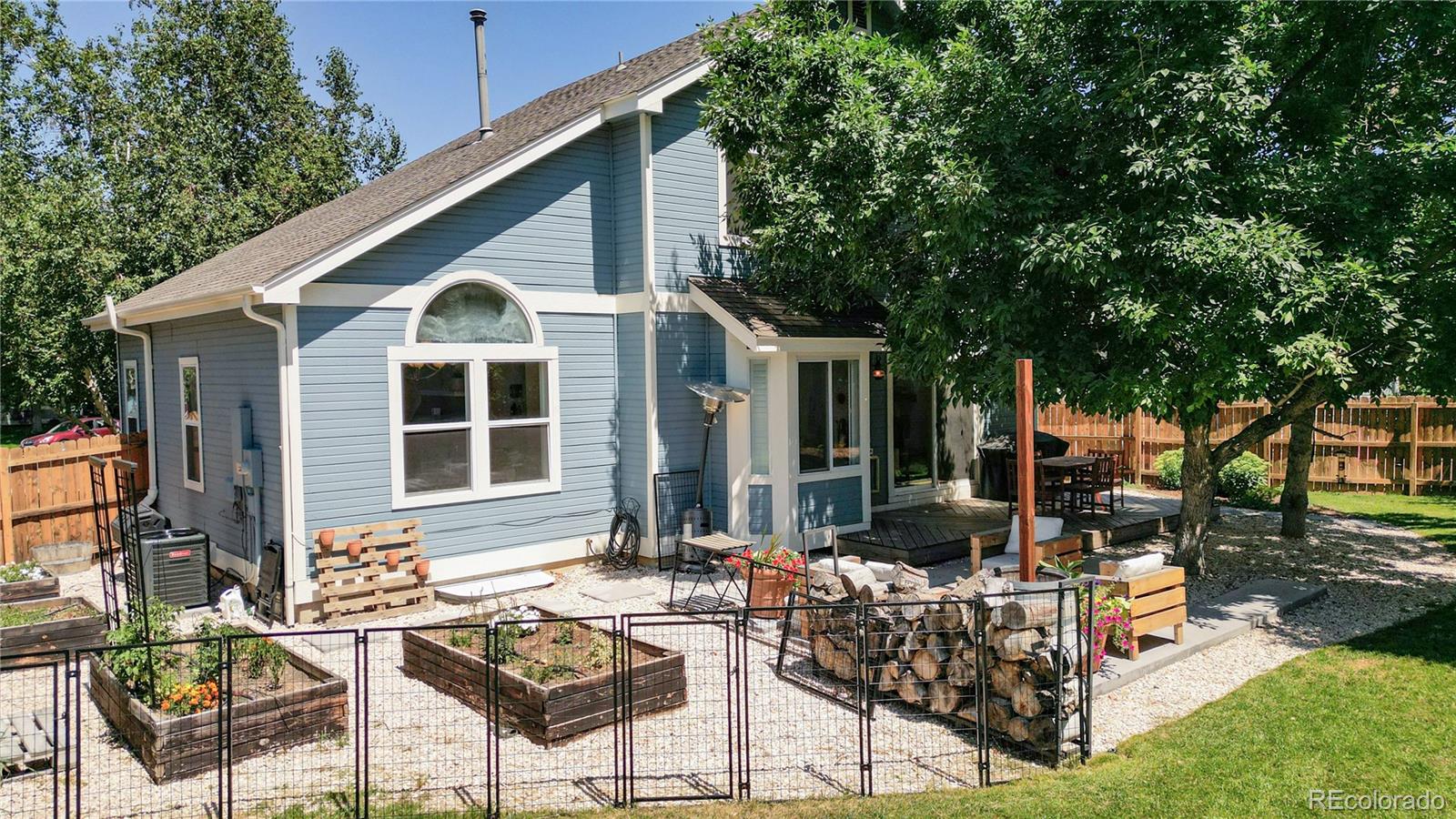 9752 Quay Loop Westminster, CO 80021 - Photo 25 of 27 a view of house with backyard outdoor seating and plants