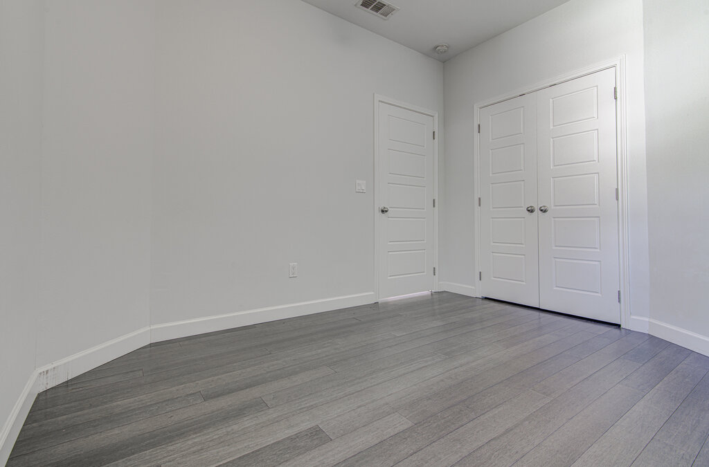 2406 East 16th Street Austin, TX 78702 - Photo 11 of 39 a view of an empty room with wooden floor