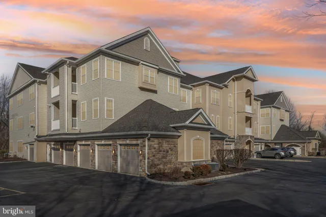 a living room with furniture and a dining table with wooden floor
