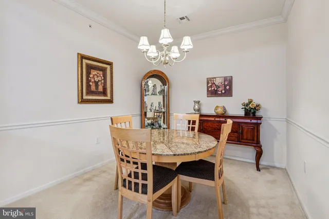 a dining room with a wooden table and chairs