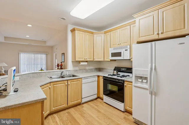 a kitchen with a sink stove top oven and cabinets