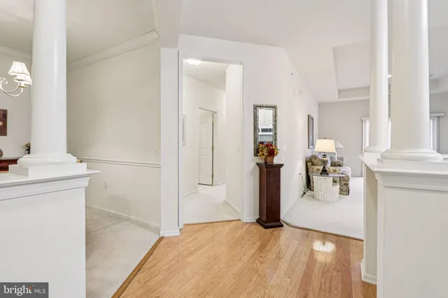 a front view of a building with lot of cars and trees