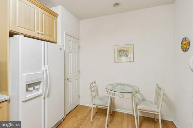 a spacious bedroom with a bed a desk and a workspace