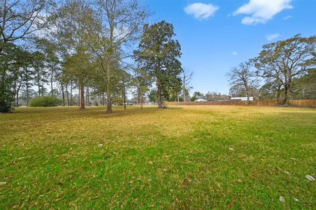 a view of yard with swimming pool and green space