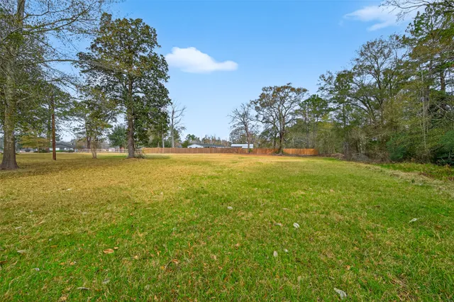 a view of yard with swimming pool and green space