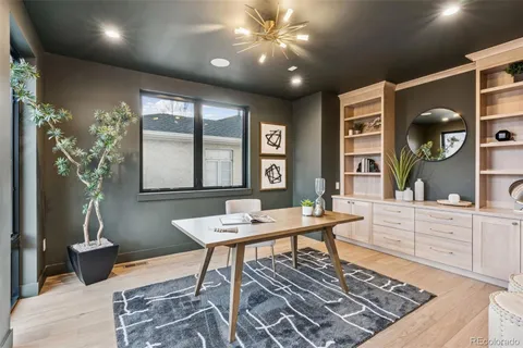 a view of a dining room with furniture a livingroom and chandelier