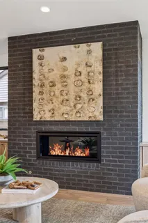 a view of a fireplace with furniture