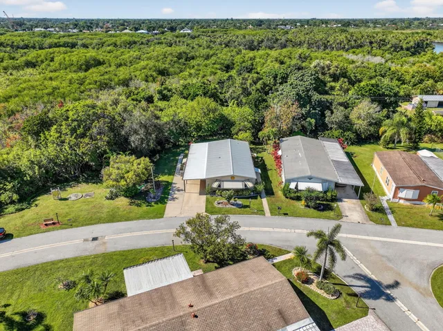 an aerial view of residential house with outdoor space and trees