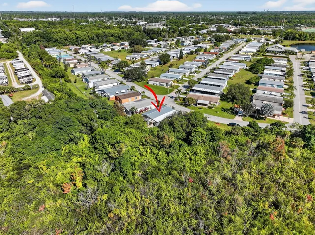 an aerial view of a house with a garden and swimming pool