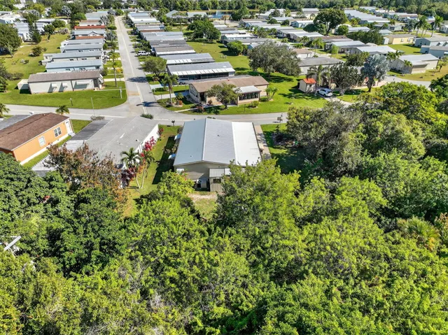 a view of empty room with wooden floor and window