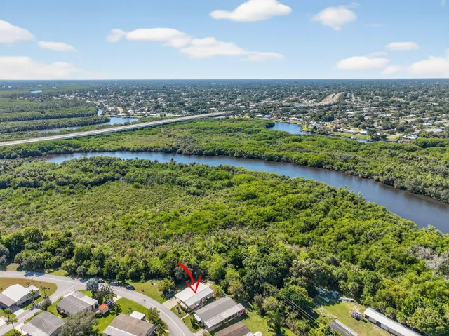 a kitchen with stainless steel appliances a stove a sink and white cabinets with wooden floor