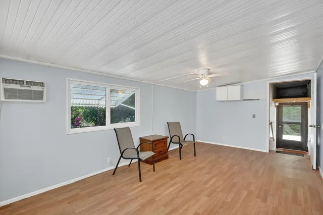 a view of a room with wooden floor
