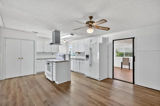 a view of a livingroom with furniture cabinets and front door