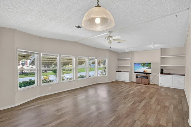 a bathroom with a granite countertop sink a toilet and a mirror