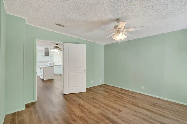 an aerial view of residential houses with outdoor space and parking