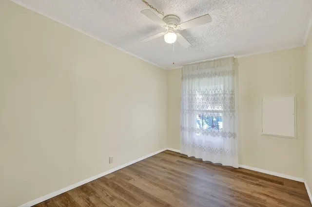 a living room with furniture a table and wooden floor