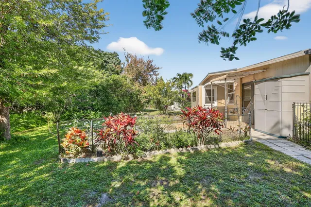 a view of a house with a yard and garden