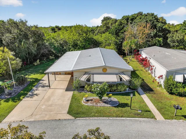 an aerial view of a house with a yard and lake view