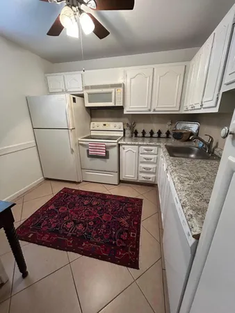 a kitchen with stainless steel appliances granite countertop a refrigerator sink and cabinets