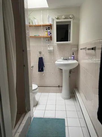 a bathroom with a sink toilet and mirror