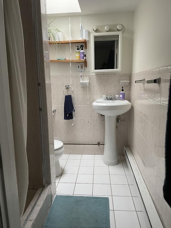 a bathroom with a sink toilet and mirror