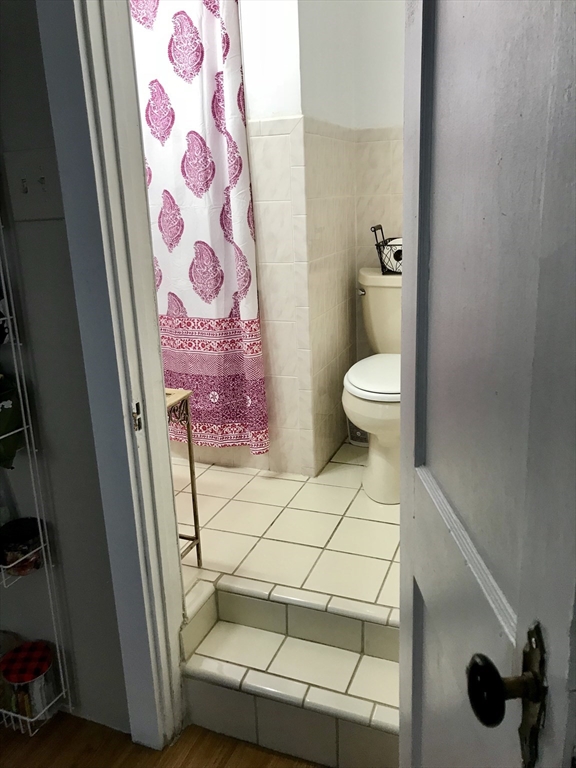 357 Windsor Street, Unit 2 Cambridge, MA 02141 - Photo 2 of 5 a bathroom with a sink and a mirror