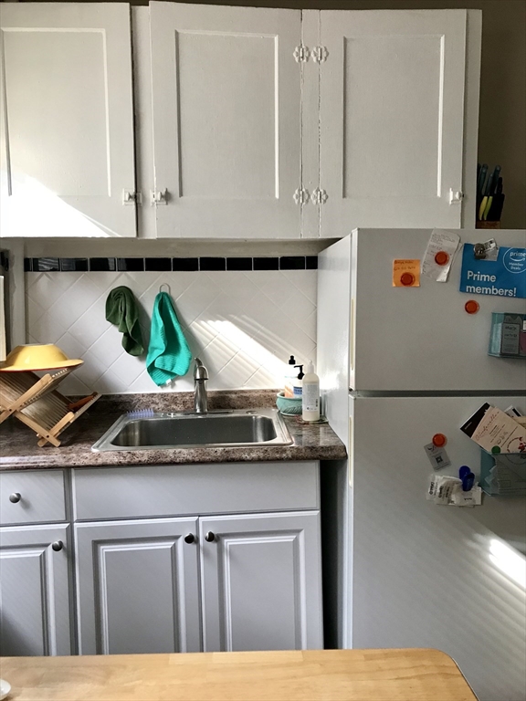 357 Windsor Street, Unit 2 Cambridge, MA 02141 - Photo 3 of 5 a kitchen with a sink a stove and cabinets