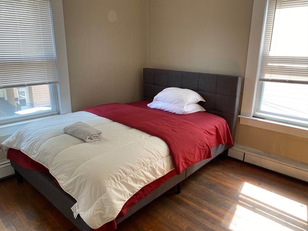 357 Windsor Street, Unit 2 Cambridge, MA 02141 - Photo 4 of 5 a bedroom with a bed and window