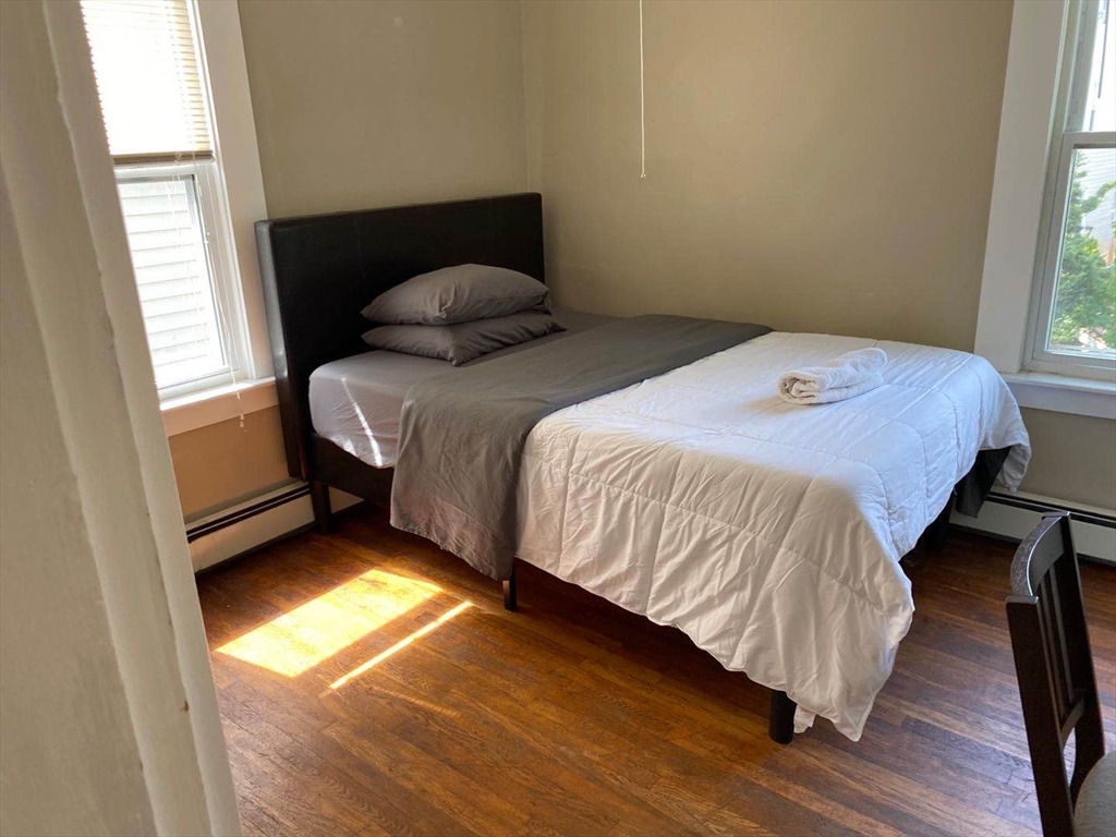 357 Windsor Street, Unit 2 Cambridge, MA 02141 - Photo 5 of 5 a bedroom with a bed and a window