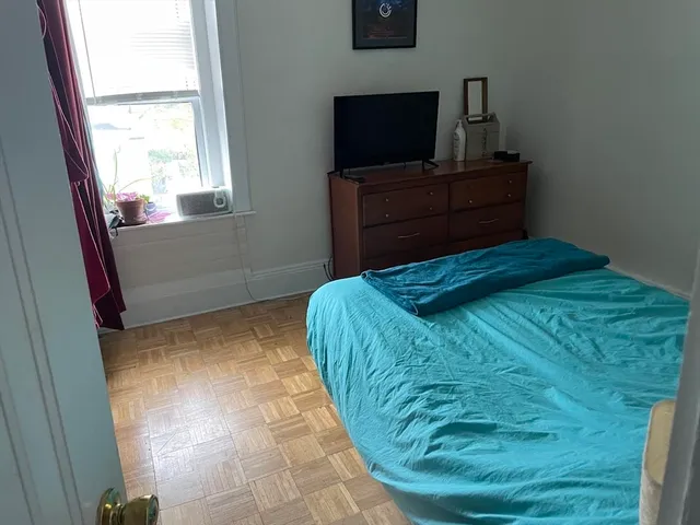 a bedroom with a bed and flat screen tv