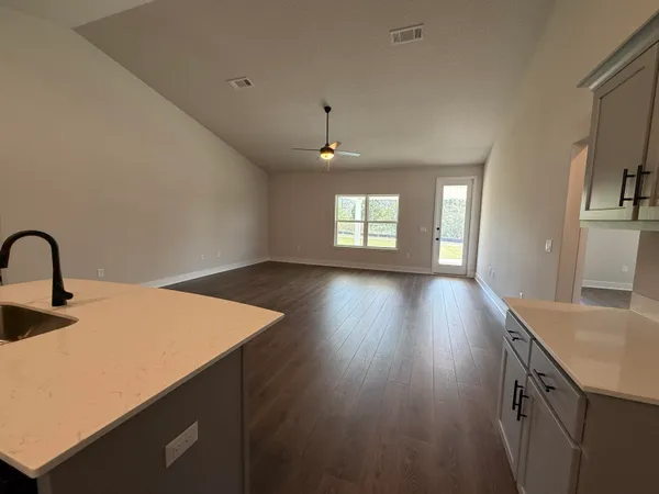 a kitchen with sink and wooden floor